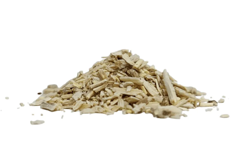 Coarse-cut dried Shatavari roots (Asparagus racemosus) pile on white background