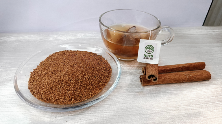 Cinnamon tea cut with cinnamon sticks and a cup of tea